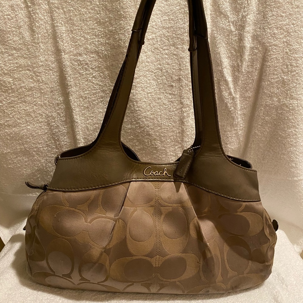 Coach signature purse has lots of pockets still in good condition.